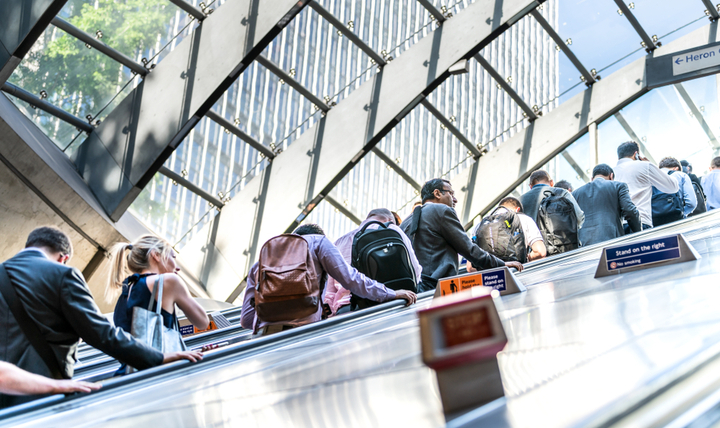 Commuters riding an escalator on the London Underground.