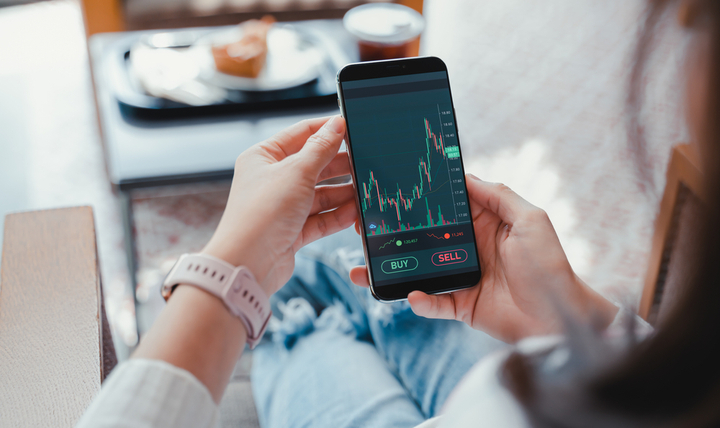 A woman checking investment performance on a phone.