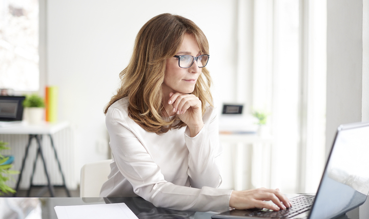 A businesswoman working on a computer.