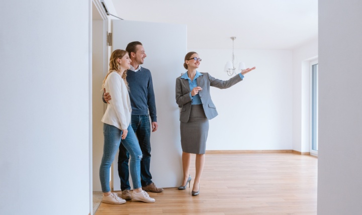 An estate agent showing a couple a property.