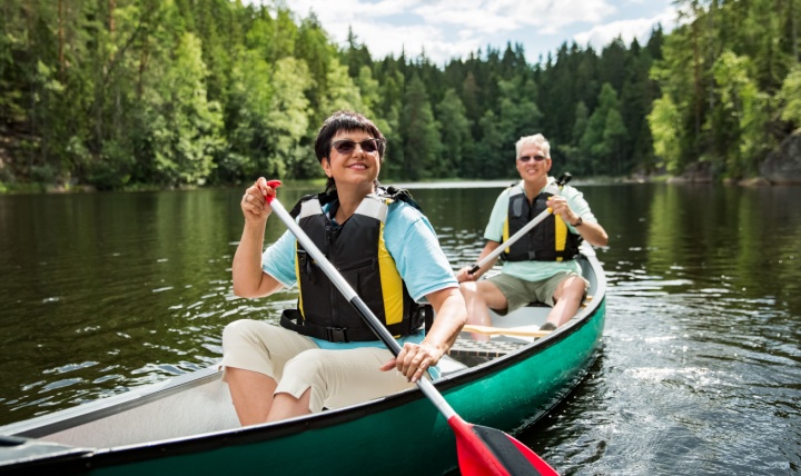 A couple in their 50s canoeing.