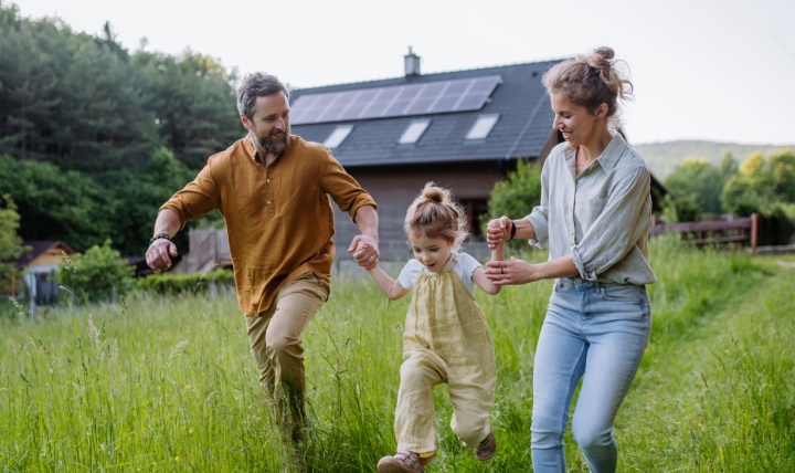 A young family playing in a garden.