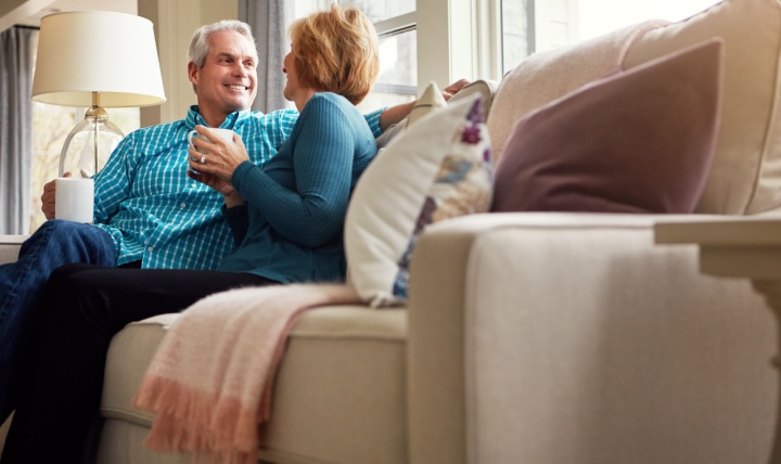 A couple sitting together in their home.