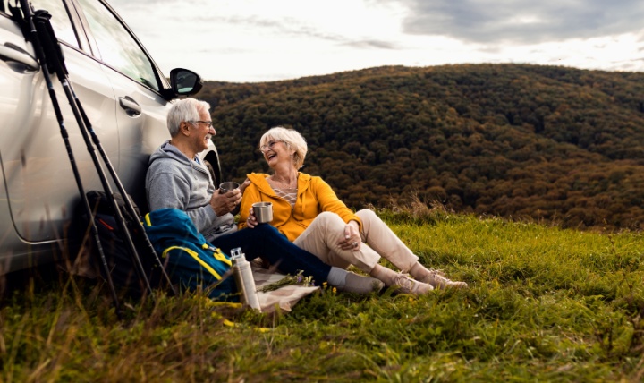 An older couple resting after a hike.