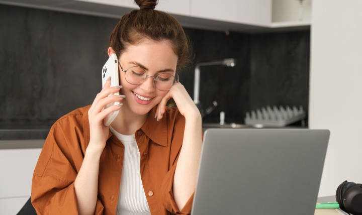 A young woman talking on the phone.