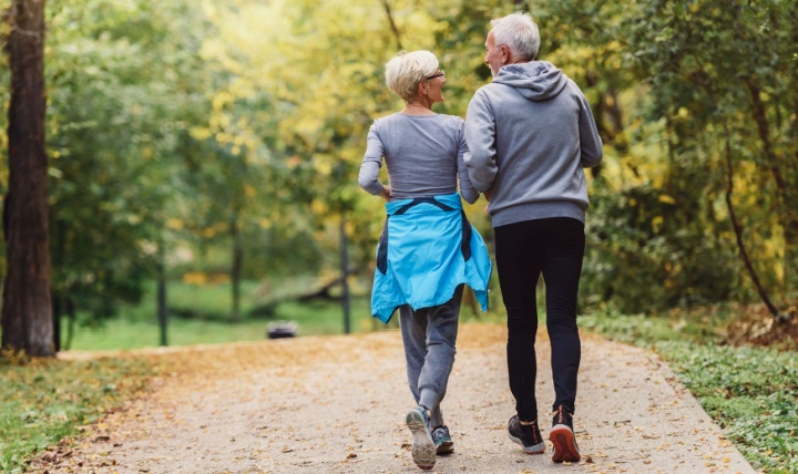 A couple jogging in a park.