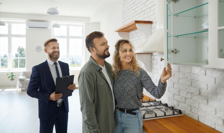 A couple viewing a property with an estate agent.