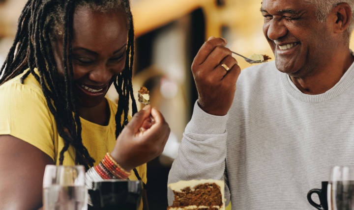 A couple laughing together at a café.