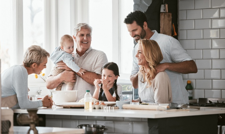 Three generations of family cooking in the kitchen