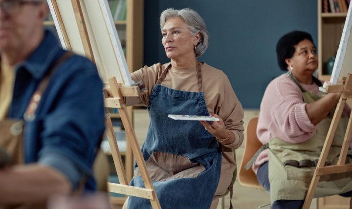 A group painting on easels in an art studio.