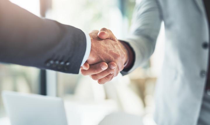 Two people shaking hands.
