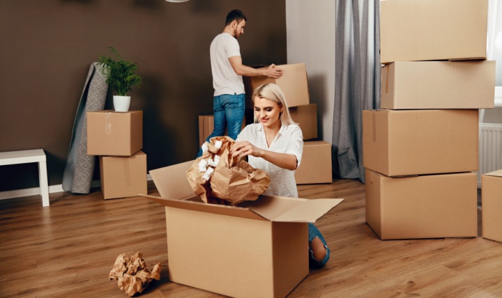 A couple unpacking boxes after moving home.