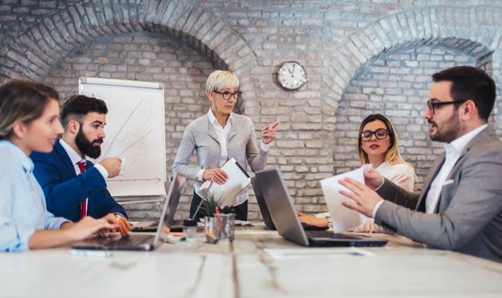 A group of colleagues sitting around a conference table.