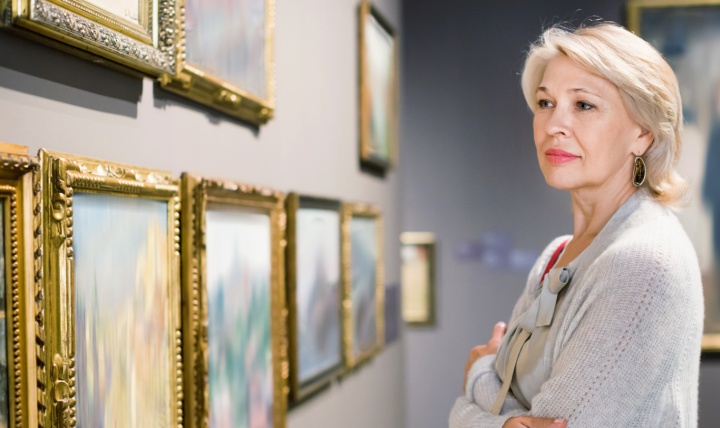 A woman looking at art in a gallery.