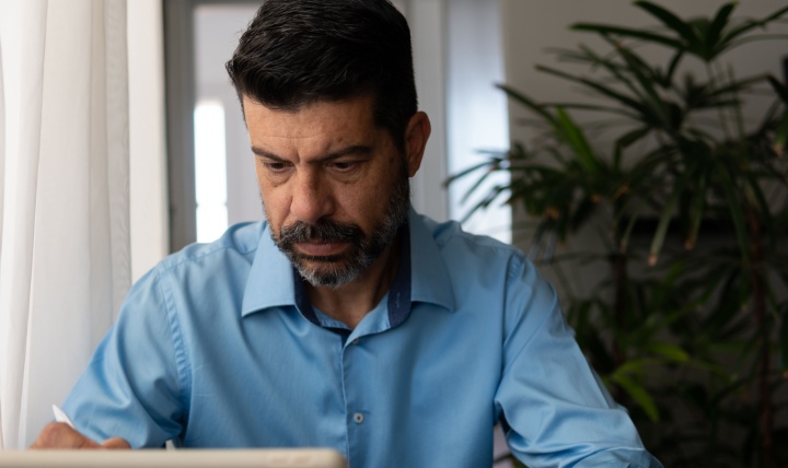 A man looking at a tablet screen.