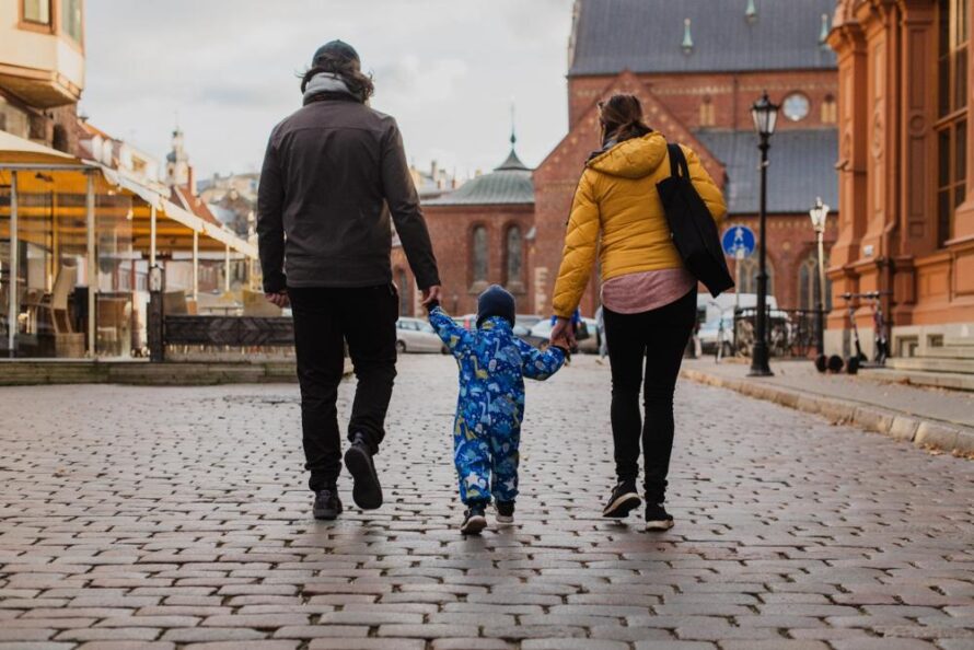 A young family walking down the street.