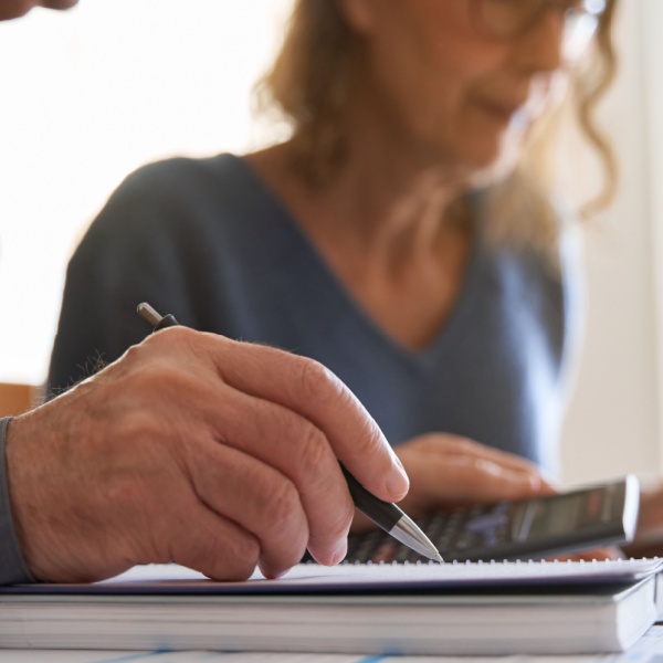 Couple looking at paperwork and using a calculator