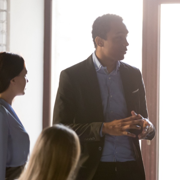A business owner speaking with his employees.