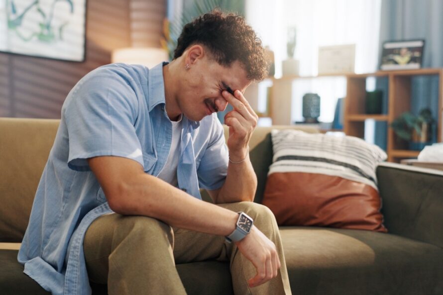A stressed man with his head in its hand.