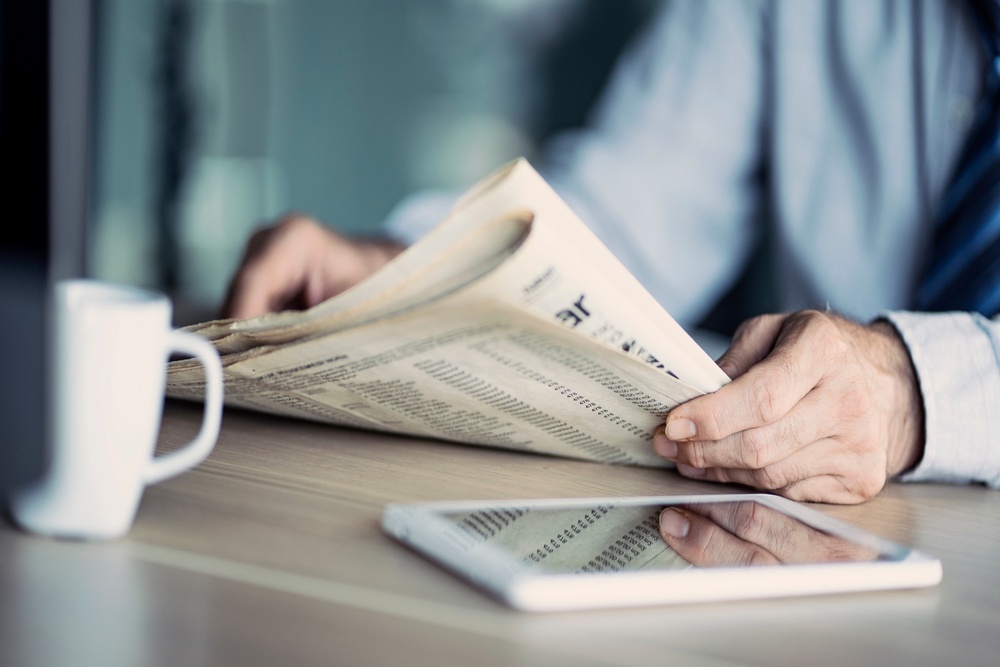 A man reading a newspaper.