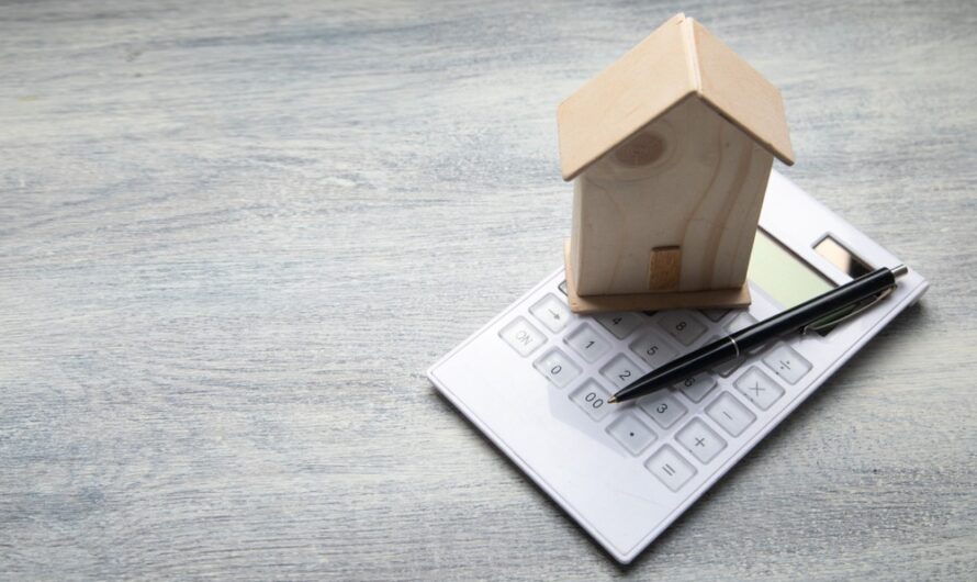 A calculator and a model of a home.