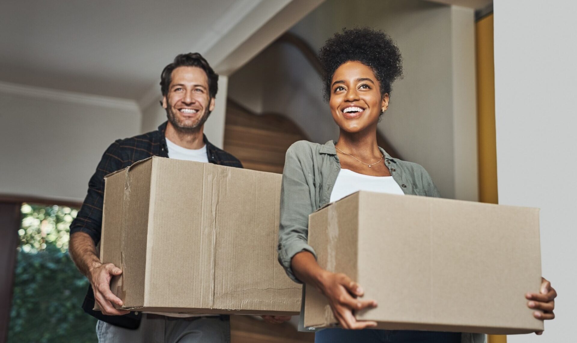 A young couple moving into their home.