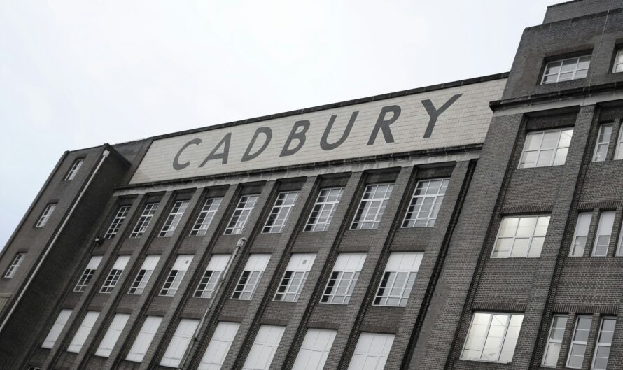 greyscale image of old English building with Cadbury sign across the front