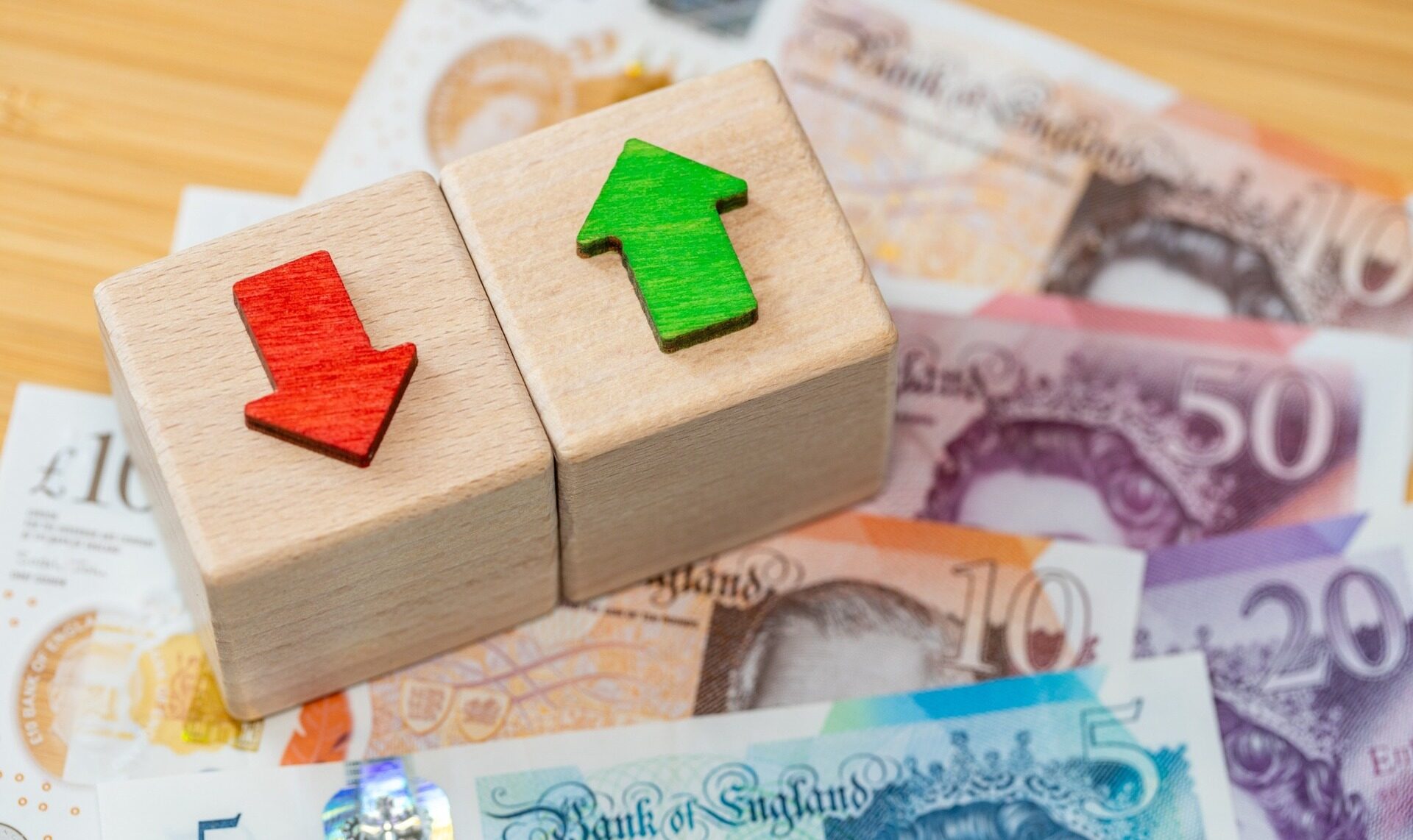 UK bank notes with arrows going up and down.