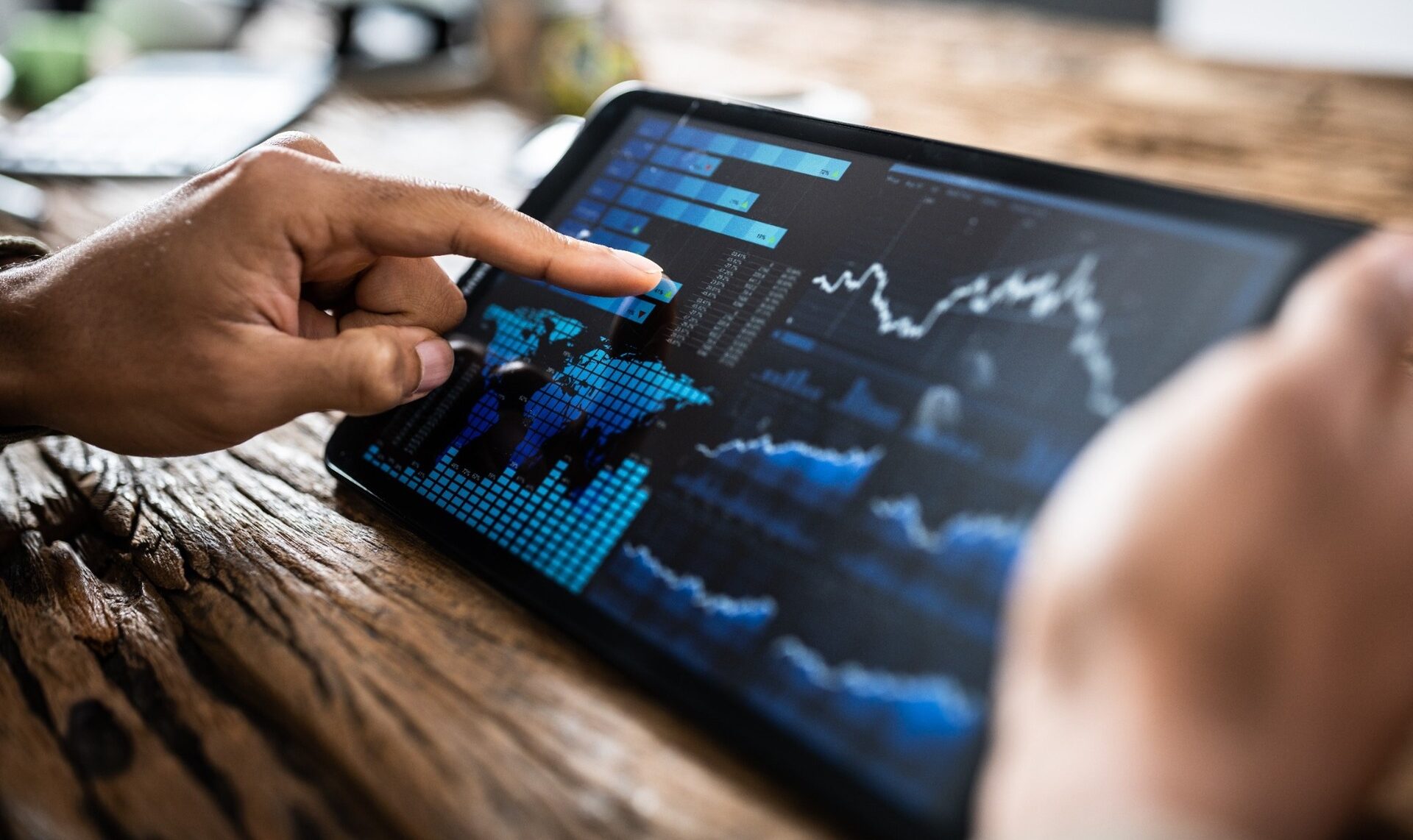 A person reviewing investment performance on a tablet.